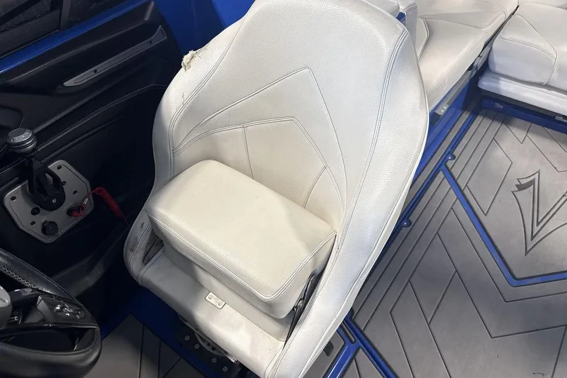 Slide: The Image of White leather seat in a 2019 Supra SA 550 boat interior. - 13
