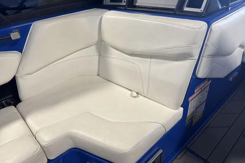 Slide: The Image of 2019 Supra SA 550 boat interior with white leather seating and blue accents. - 17