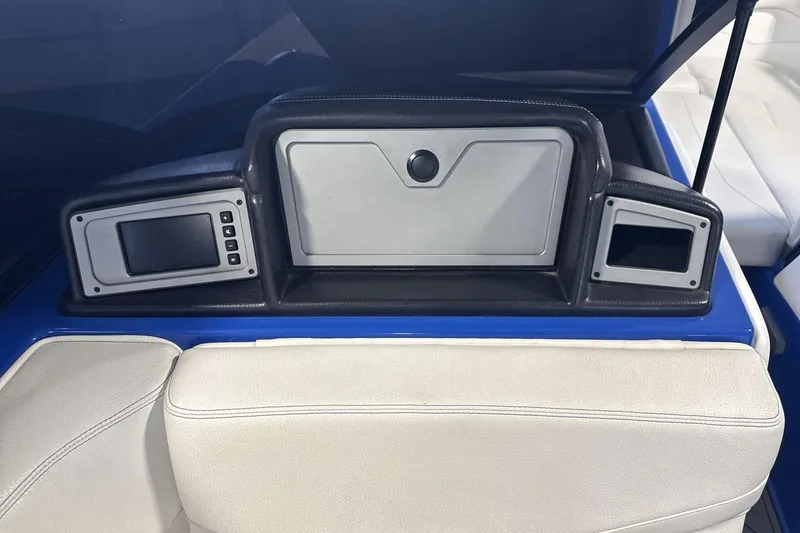 Slide: The Image of 2019 Supra SA 550 boat dashboard with digital displays and storage compartment. - 18