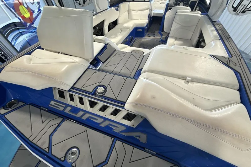 Slide: The Image of Interior of 2019 Supra SA 550 boat with white seating and blue accents. - 19