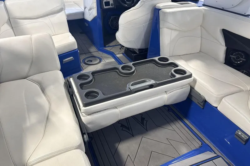 Slide: The Image of Interior of 2019 Supra SA 550 boat with white seating and cup holders. - 23