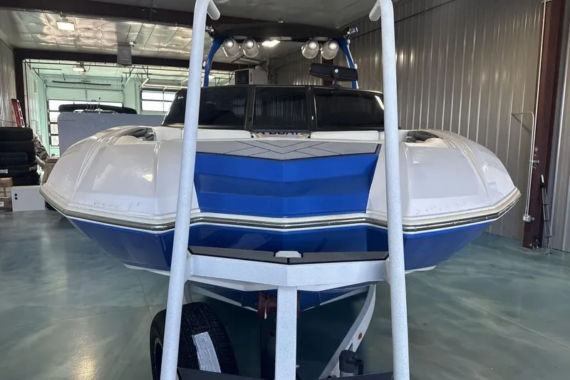 Slide: The Image of 2019 Supra SA 550 boat in storage, featuring a sleek blue and white design. - 8