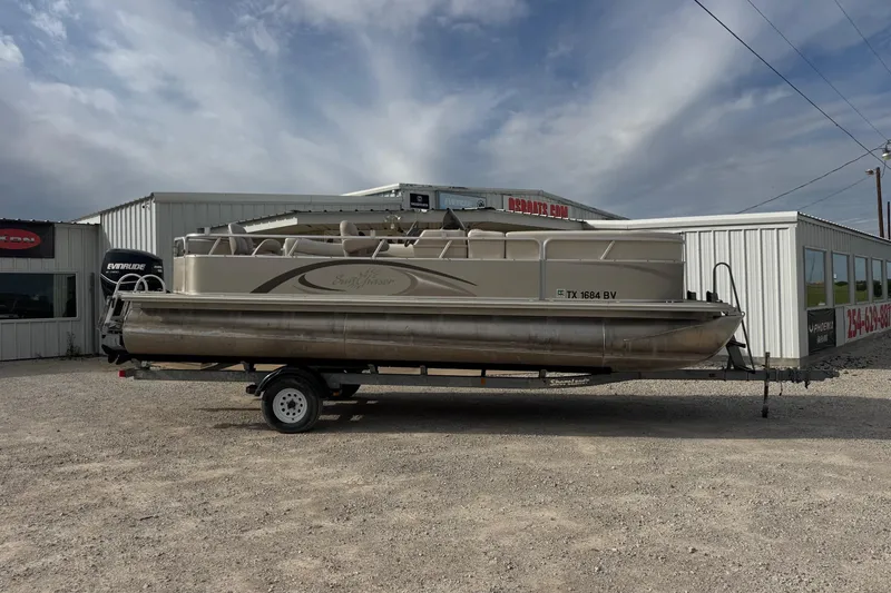 The Image of 2013 SunChaser 8522 Cruise pontoon boat on trailer, parked outside dealership. - 0