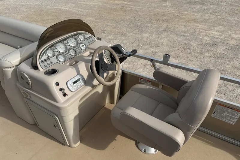 Slide: The Image of 2013 SunChaser 8522 Cruise boat dashboard with steering wheel and control panel. - 10