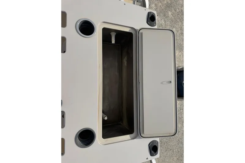 Slide: The Image of Open storage compartment on a 2013 SunChaser 8522 Cruise boat, featuring cup holders. - 6