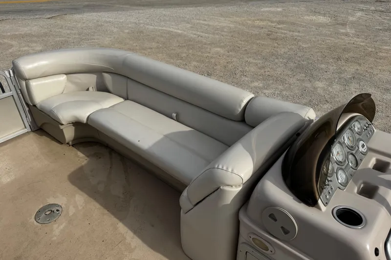 Slide: The Image of 2013 SunChaser 8522 Cruise boat interior with beige seating and control panel. - 9