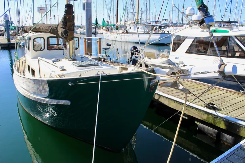 Slide: The Image of 1972 Fisher 30 sailboat docked in a marina, surrounded by other boats. - 1