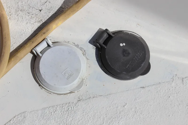 Slide: The Image of Deck fittings on a 1972 Fisher 30 boat, featuring white and black covers. - 11