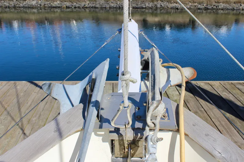 Slide: The Image of Bow of a 1972 Fisher 30 boat docked by calm water. - 12