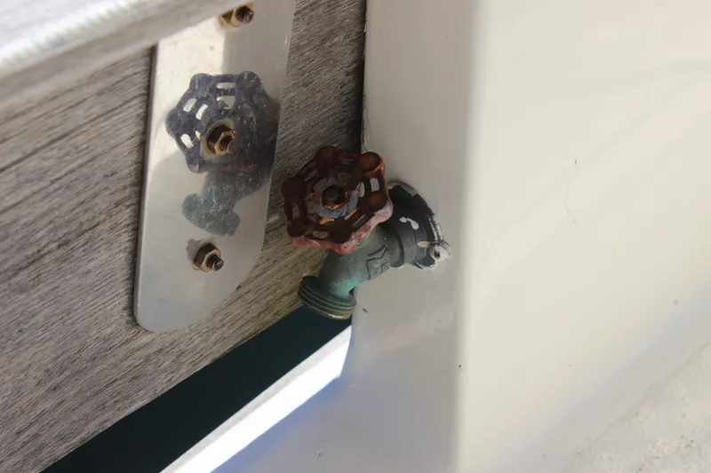 Slide: The Image of Rusty valve on a 1972 Fisher 30 boat, mounted on a wooden panel. - 14