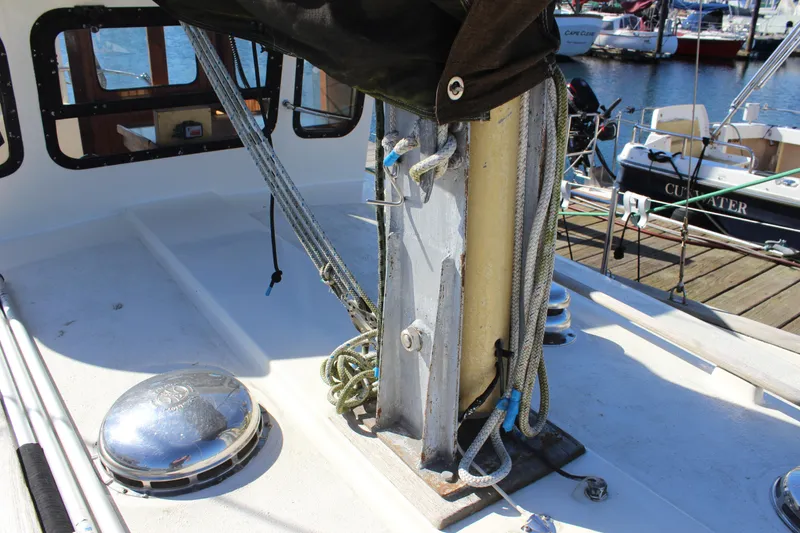 Slide: The Image of Deck of a 1972 Fisher 30 sailboat with rigging and ropes. - 15