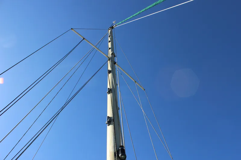 Slide: The Image of Mast of a 1972 Fisher 30 sailboat against a clear blue sky. - 16