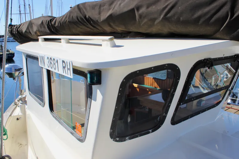 Slide: The Image of 1972 Fisher 30 boat cabin with registration number, docked in a marina. - 17