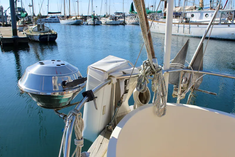 Slide: The Image of Sailboat deck view with grill, ropes, and marina background, Fisher 30, 1972 model. - 18