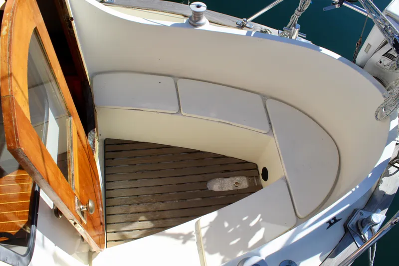 Slide: The Image of 1972 Fisher 30 sailboat cockpit with wooden door and seating area. - 19