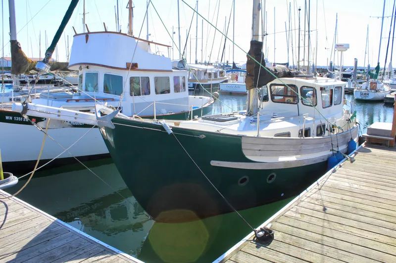 Slide: The Image of 1972 Fisher 30 sailboat docked in a marina, surrounded by other boats. - 2