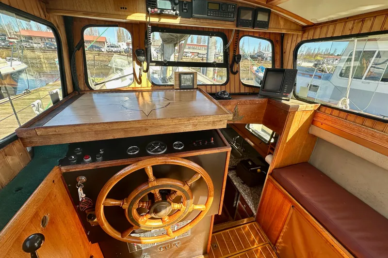 Slide: The Image of Interior of a 1972 Fisher 30 boat with wooden helm and navigation equipment. - 23