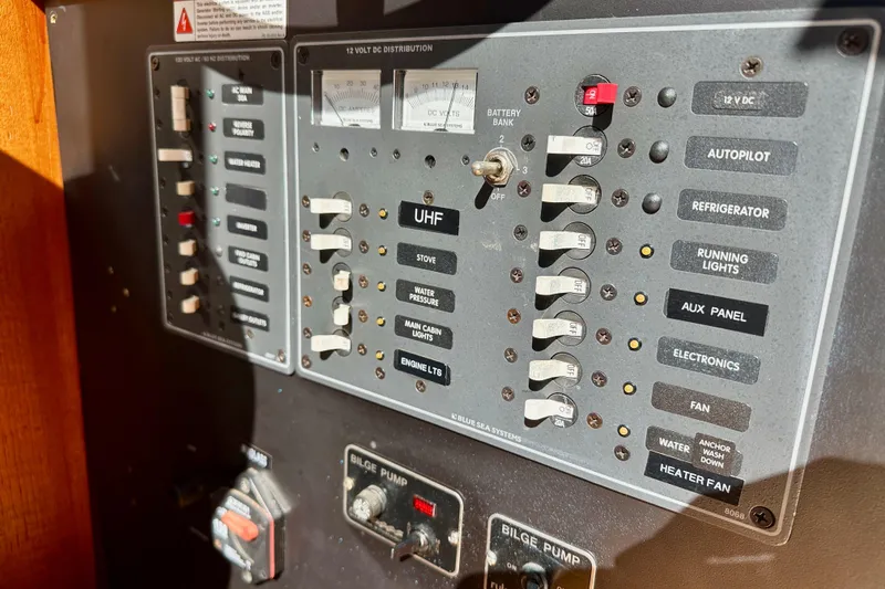 Slide: The Image of Electrical control panel on a 1972 Fisher 30 boat, featuring various switches and gauges. - 27