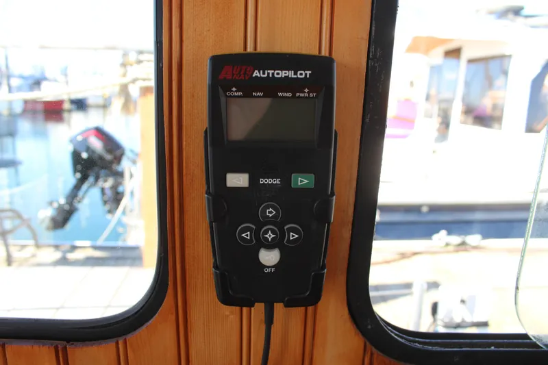 Slide: The Image of Autopilot control panel on 1972 Fisher 30 boat, mounted on wooden interior. - 28