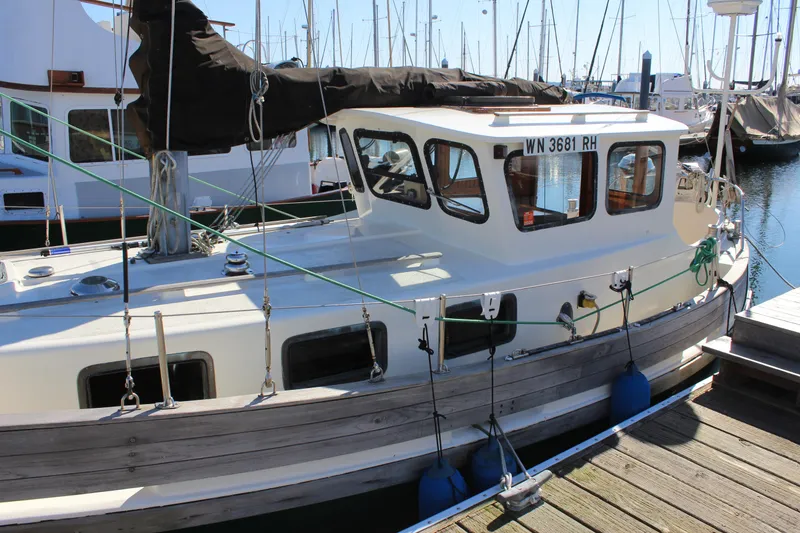 Slide: The Image of 1972 Fisher 30 sailboat docked at a marina with other boats. - 3