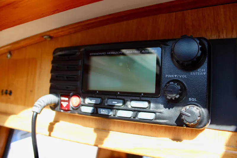 Slide: The Image of Standard Horizon radio on 1972 Fisher 30 boat, featuring control knobs and display. - 30