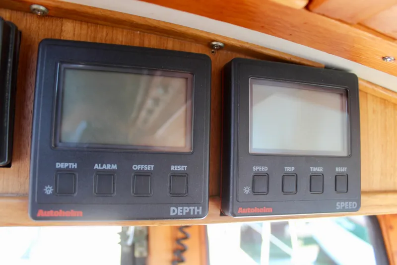 Slide: The Image of Vintage 1972 Fisher 30 boat dashboard with Autopilot depth and speed displays. - 31