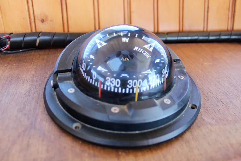 Slide: The Image of Ritchie compass on a 1972 Fisher 30 boat, mounted on a wooden surface. - 34