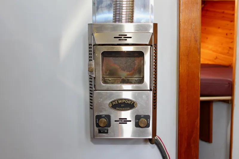 Slide: The Image of Stainless steel Newport by Dickinson heater inside a 1972 Fisher 30 boat cabin. - 37