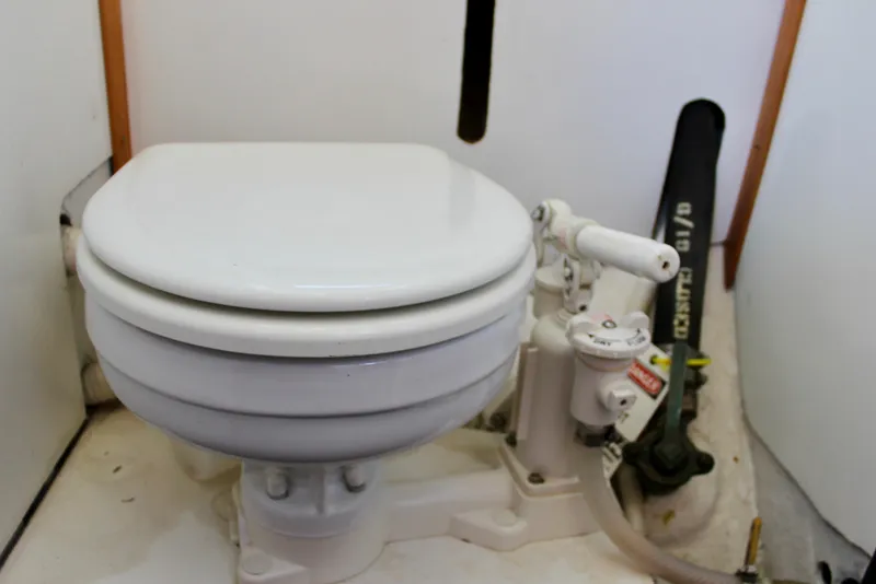 Slide: The Image of 1972 Fisher 30 marine toilet with manual pump in a compact boat bathroom. - 51