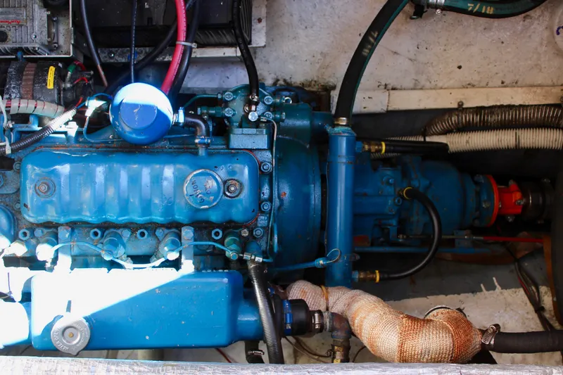 Slide: The Image of 1972 Fisher 30 engine compartment with blue machinery and various hoses. - 58