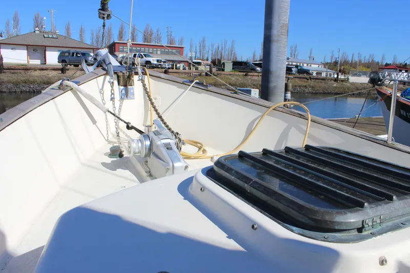 Slide: The Image of Bow of a 1972 Fisher 30 boat with anchor and winch in a marina. - 9