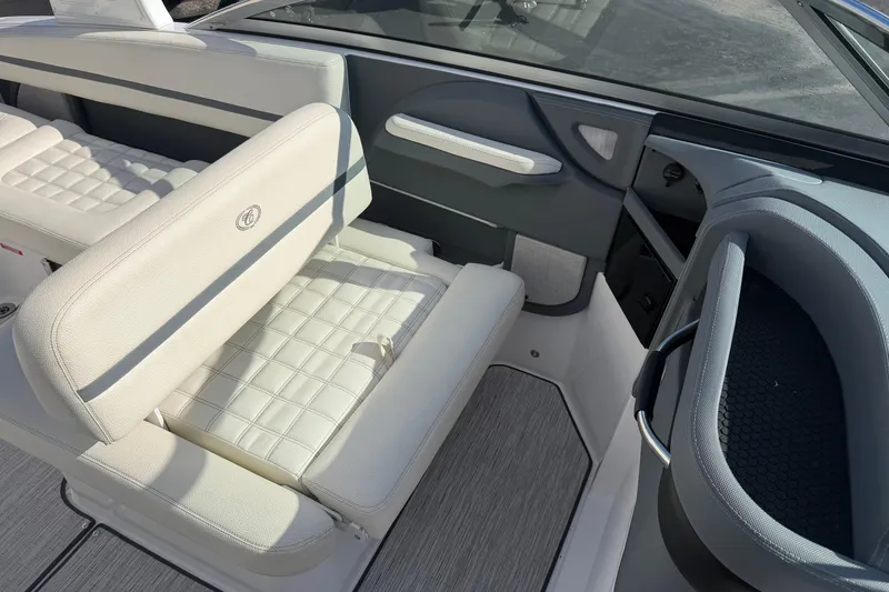 Slide: The Image of 2019 Cobalt R5 boat interior with white cushioned seating and sleek design. - 17