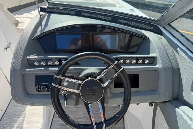 Slide: The Image of Steering wheel and dashboard of a 2019 Cobalt R5 boat, featuring modern controls and displays. - 26