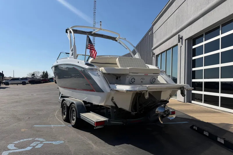 Slide: The Image of 2019 Cobalt R5 boat on trailer, parked outside a building under clear blue sky. - 3