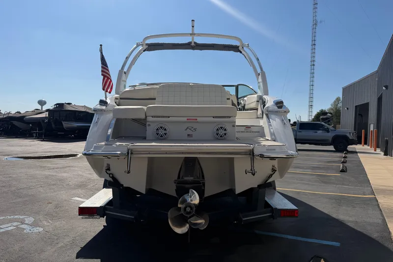 Slide: The Image of 2019 Cobalt R5 boat on trailer, rear view, parked outdoors with American flag. - 4
