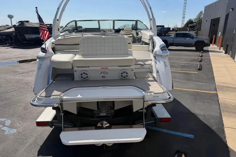 Slide: The Image of 2019 Cobalt R5 boat with American flag, parked in a marina lot. - 5