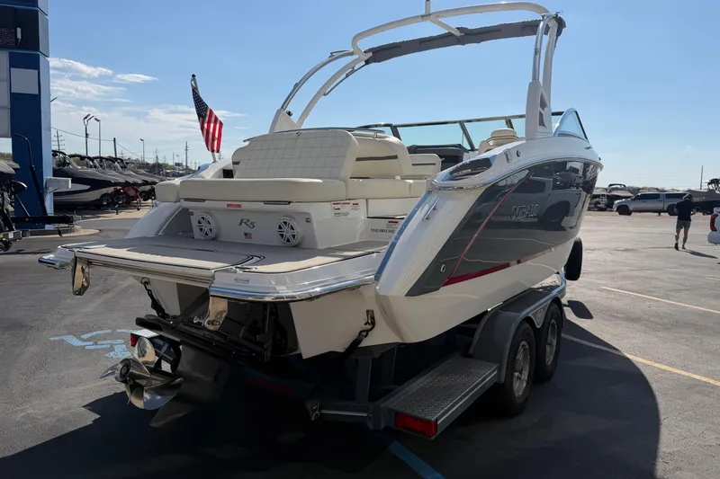 Slide: The Image of 2019 Cobalt R5 boat on trailer, rear view with American flag in background. - 6