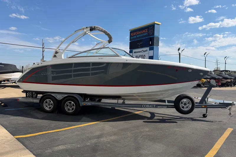 Slide: The Image of 2019 Cobalt R5 boat on trailer at a marine dealership under a clear blue sky. - 7