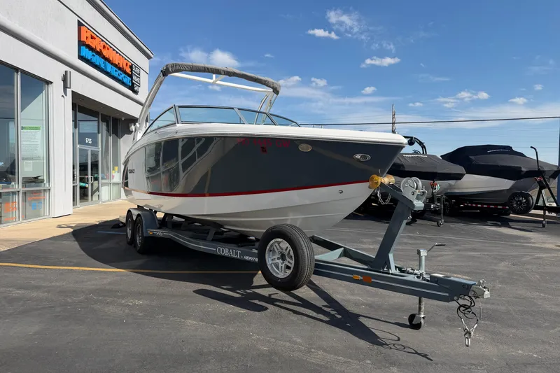 Slide: The Image of 2019 Cobalt R5 boat on trailer outside marine dealership under blue sky. - 8