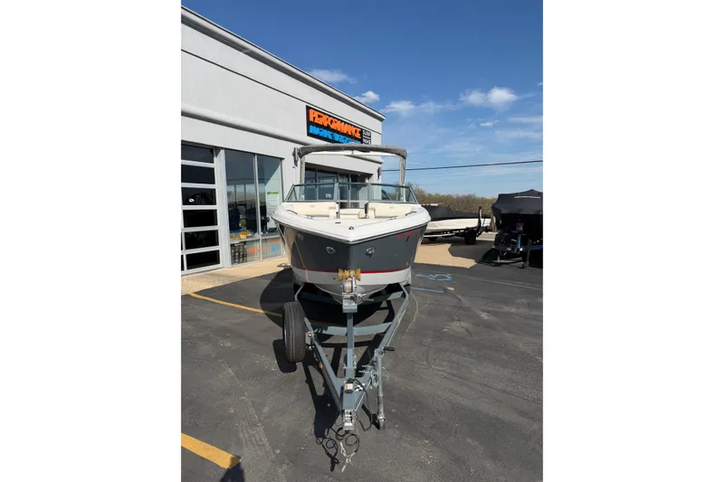 Slide: The Image of 2019 Cobalt R5 boat on trailer outside dealership under clear blue sky. - 9