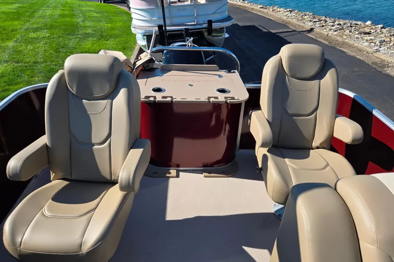 Slide: The Image of Luxurious seating on 2023 SunChaser Geneva Fish 22 pontoon boat by the water. - 17