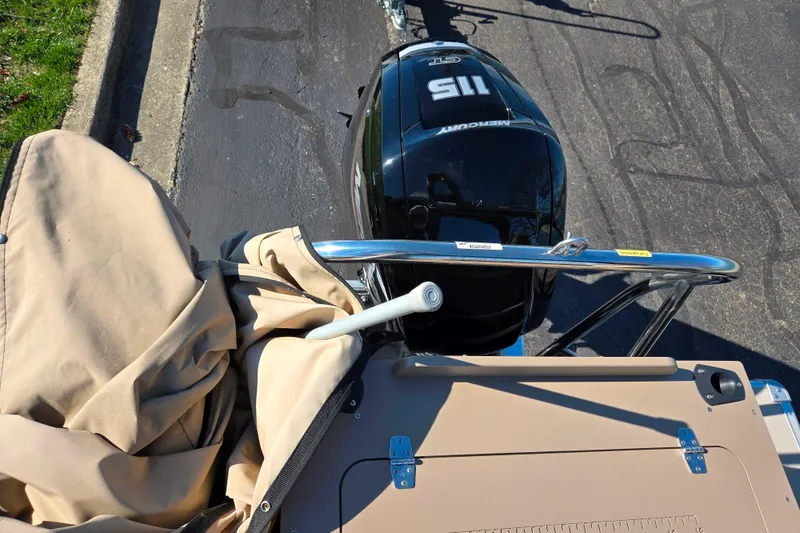 Slide: The Image of 2023 SunChaser Geneva Fish 22 boat with Mercury 115 engine, beige cover, and metal railing. - 20