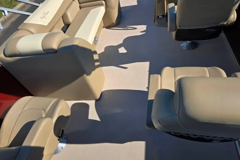 Slide: The Image of 2023 SunChaser Geneva Fish 22 boat interior with beige seating and carpet. - 22