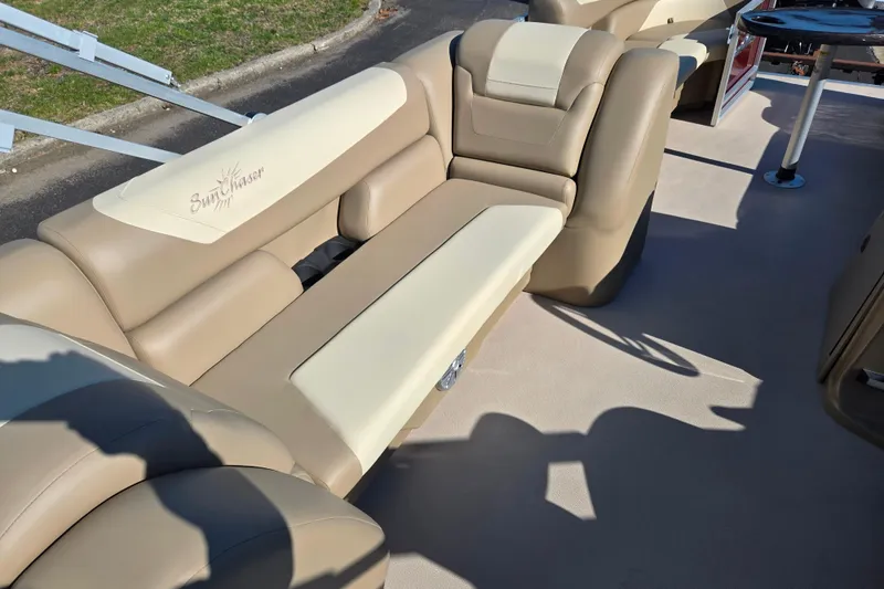 Slide: The Image of 2023 SunChaser Geneva Fish 22 boat interior with beige seating and SunChaser logo. - 23