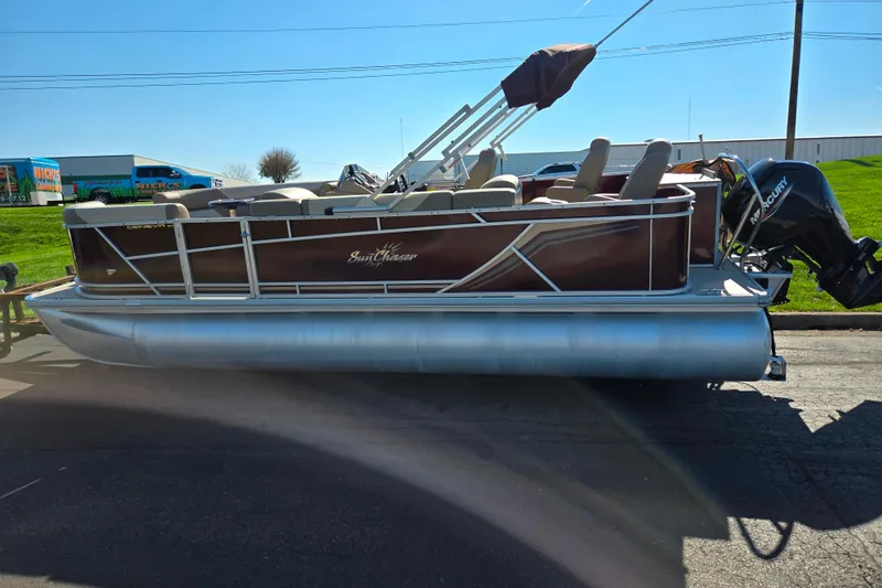 Slide: The Image of 2023 SunChaser Geneva Fish 22 pontoon boat with Mercury outboard motor on display. - 4