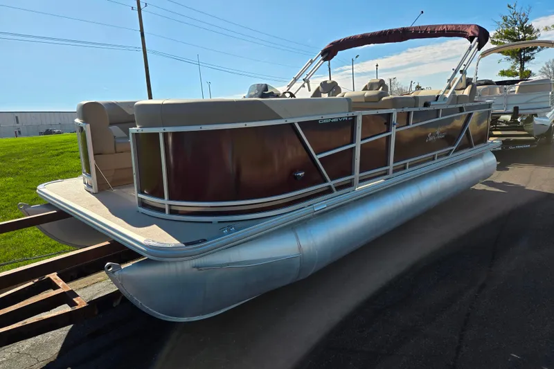 Slide: The Image of 2023 SunChaser Geneva Fish 22 pontoon boat with maroon exterior and beige seating. - 5