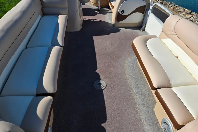 Slide: The Image of Interior of a 2016 Sun Tracker Party Barge 24 DLX with beige seating. - 10