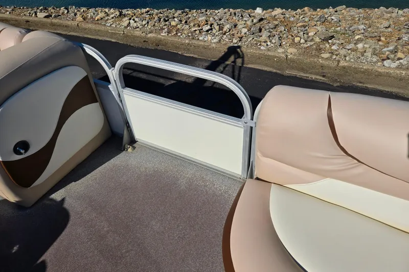 Slide: The Image of Interior view of a 2016 Sun Tracker Party Barge 24 DLX pontoon boat with beige seating. - 12