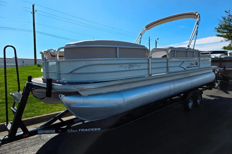 Slide: The Image of 2016 Sun Tracker Party Barge 24 DLX pontoon boat on trailer, parked outdoors. - 5