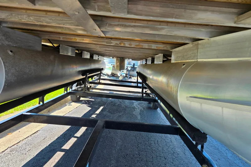 Slide: The Image of Underneath view of a 2016 Sun Tracker Party Barge 24 DLX pontoon boat on a trailer. - 7